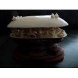 A 19TH CENTURY HAND CARVED IVORY PIECE, in the form of a clam shell, with intricately carved village