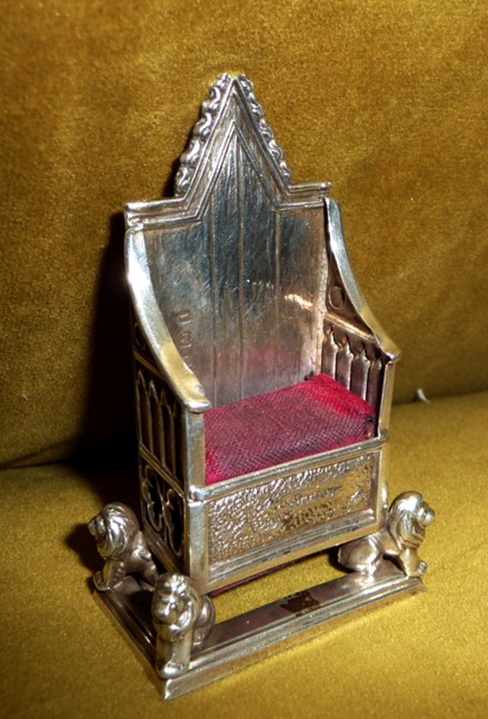 A GEORGE V SILVER CORONATION PIN CUSHION, in the form of a thorn, with original scarlet velvet