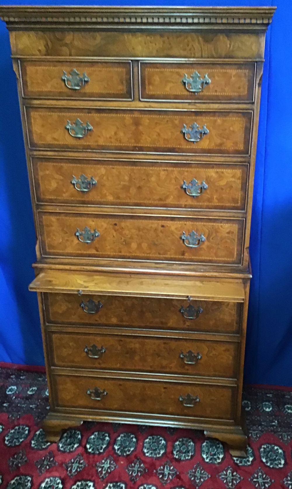 A GOOD QUALITY WALNUT CROSSBANDED CHEST ON CHEST, with brush slide, oak linings, raised on shaped - Image 2 of 3