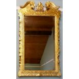 AN 18TH CENTURY GEORGE I GILT GESSO WALL MIRROR with rectangular bevelled plate, the frame having