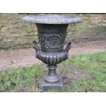 A PAIR OF GOOD QUALITY CAST IRON BRONZED URNS with Lionhead decoration, 63cm high x 48cm wide