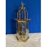 A BRASS 6 SIDED GLASS HANGING LANTERN, with bevelled glass panels, 73cm high