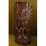 A HARDWOOD CARVING, early – mid 20th Century depicting Lord Vishnu atop Garuda Bali, possibly