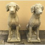 A PAIR OF STONE GARDEN ORNAMENTS IN THE FORM OF HOUNDS, 73cm high approx