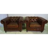 A GOOD QUALITY 20TH CENTURY PAIR OF LEATHER HIDE CHESTERFIELD ARMCHAIRS, with button back and roll