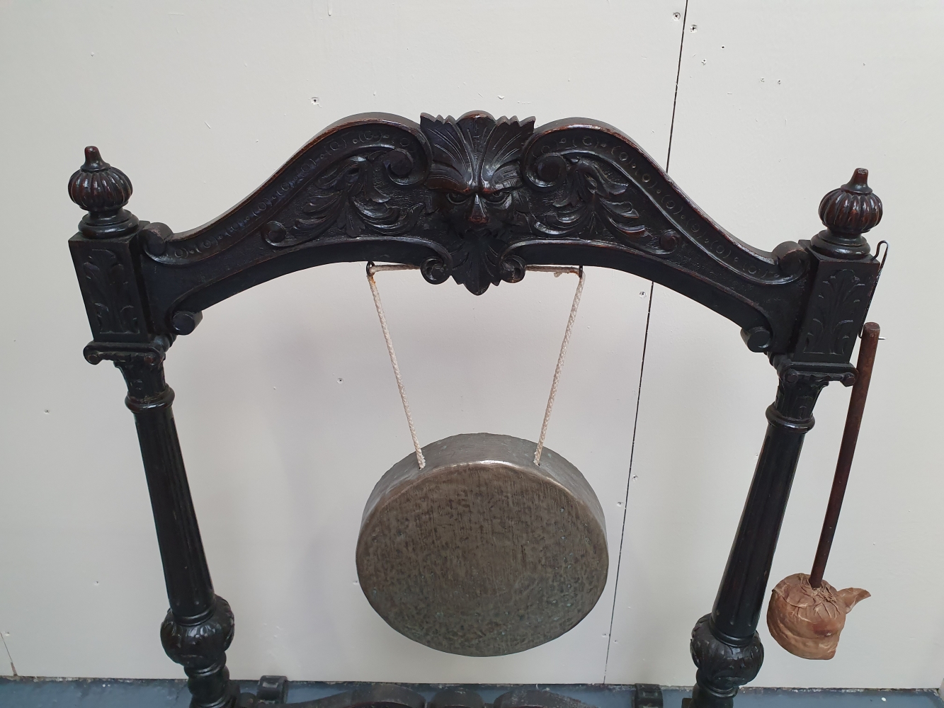 A 19TH CENTURY OAK FRAMED DINNER GONG - with carved mask head and brass gong, 48in x 32.25in x 21. - Image 2 of 2