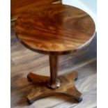 AN EARLY 19TH CENTURY MAHOGANY OCCASIONAL TABLE, with figured circular top, raised on a central