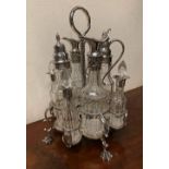 A 19TH CENTURY SILVER PLATED 8 BOTTLE CRUET SET, raised on four claw feet, c.1870, 10" high