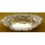 A LARGE SILVER DISH, the rim decorated with repoussé detail and the body having pierced lattice