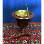 A MAHOGANY WILLIAM IV INLAID WINE BUCKET / JARDINÉRE STAND on a pod base, 51cm tall approx