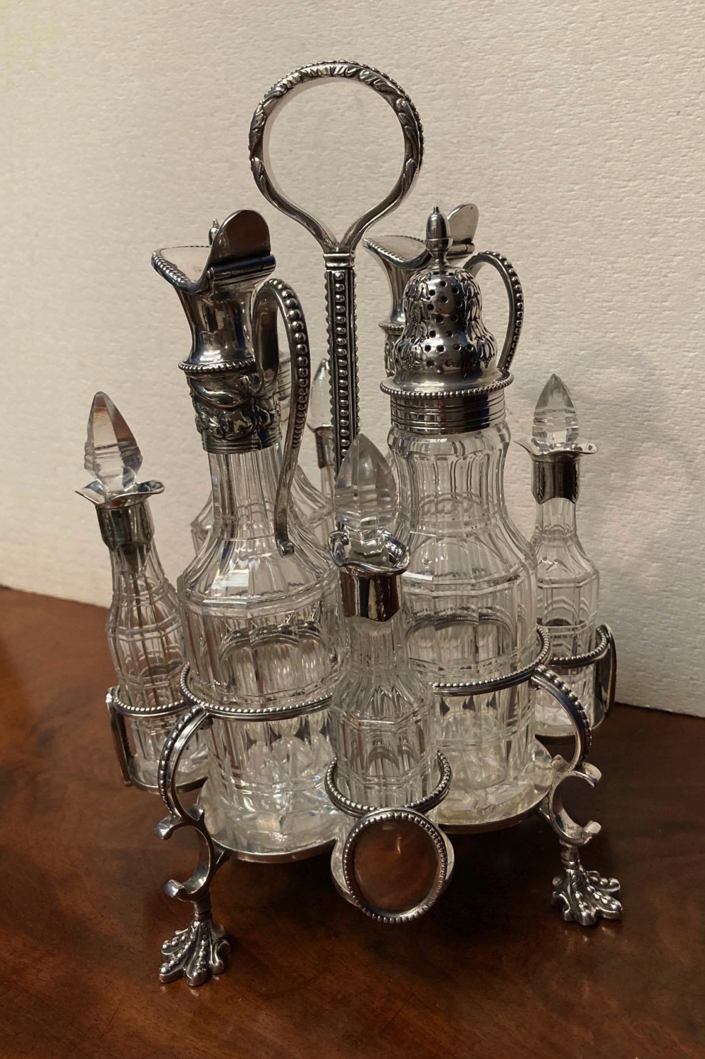 A 19TH CENTURY SILVER PLATED 8 BOTTLE CRUET SET, raised on four claw feet, c.1870, 10" high - Image 3 of 4