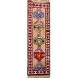 A VERY FINE PERSIAN FLOOR RUNNER, hand knotted, with large diamond shaped geometric motif in the