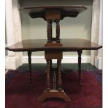 AN UNUSUAL TWO TIERED SUTHERLAND TABLE, each tier with canted corners, raised on ring turned