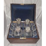 A GOOD QUALITY 19TH CETURY DOMED DECANTER BOX, mahogany, with a set of 4 decanters and 6 glasses, in