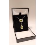 AN 18CT WHITE GOLD PERIDOT & DIAMOND ART DECO STYLE PENDANT NECKLACE, this pieces is hand made and