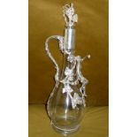 AN ORNATE CLARET JUG, with silver plated detailing depicting a cherub embracing the body of the
