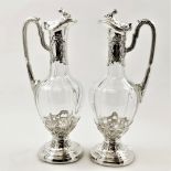 A VERY FINE PAIR OF LATE 19TH CENTURY GERMAN ANTIQUE SILVER & GLASS CLARET JUGS, with 800 standard