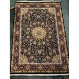 A GOOD QUALITY ISFAHAN WOOL RUG, with multiple borders and deep blue main ground having floral motif