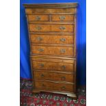 A GOOD QUALITY WALNUT CROSSBANDED CHEST ON CHEST, with brush slide, oak linings, raised on shaped