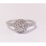 AN 18CT WHITE GOLD DIAMOND HALO RING, centre diamond .55cts total diamond weight 1ct, great