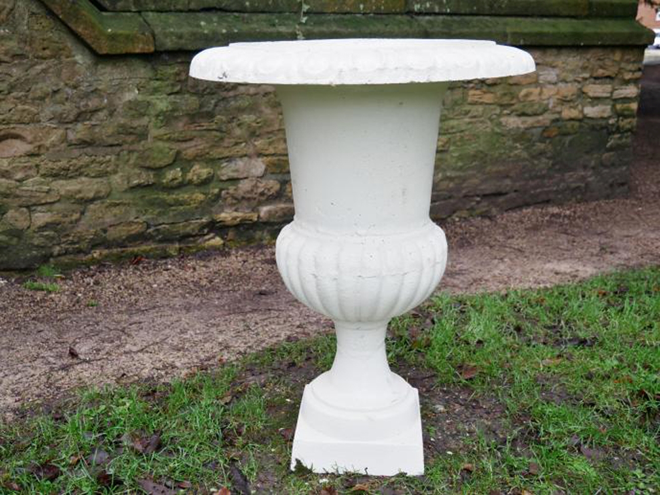 A PAIR OF CAMPANA STYLE WHITE CAST IRON GARDEN URNS, 73cm high x 58cm wide