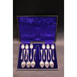 TWO SETS OF SILVER SPOONS & A SUGAR TONGS, cased, silver plated, 12 spoons, 1 tongs