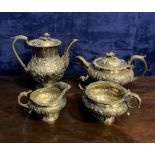 A GEORGIAN FOUR PIECE SILVER TEA SET to include a coffee pot, teapot, sugar bowl and milk jug,