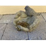 A GARDEN BIRD BATH, in the form of two hands holding a bird