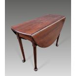 A VERY FINE GEORGIAN MAHOGANY DROP LEAF TABLE, circa 1760, with round solid mahogany top, raised