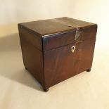 A GEORGE III EARLY 18TH CENTURY MAHOGANY VENEERED TEA CADDY, oblong in shape, with brass stringing