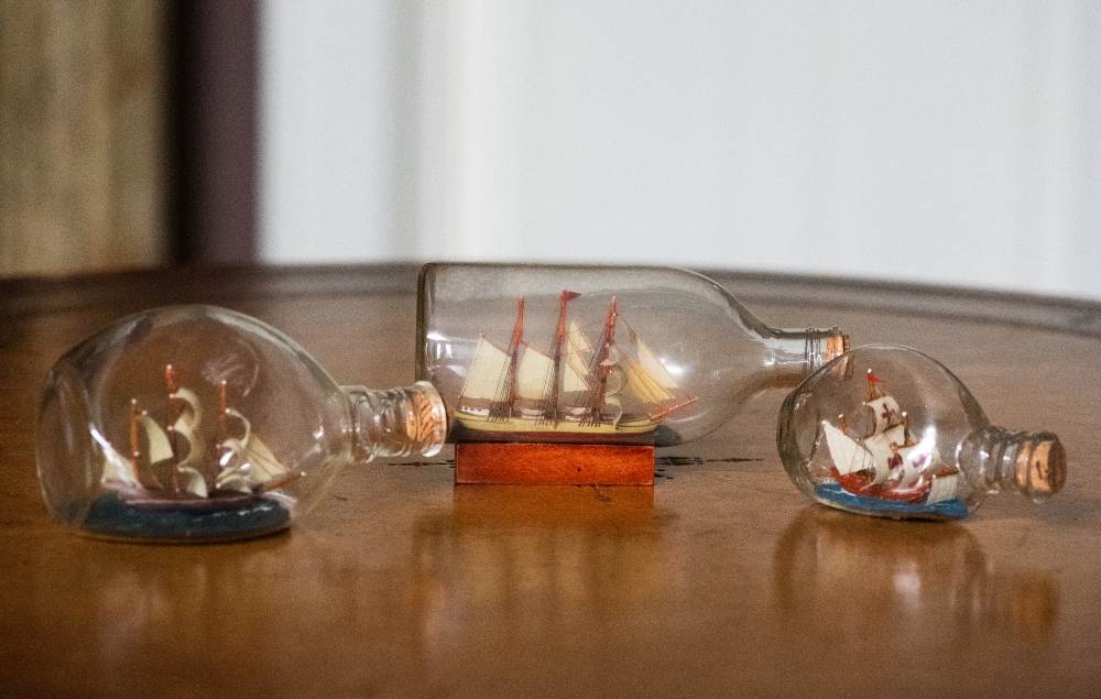 THREE SHIPS IN BOTTLES, largest 18cm long approx