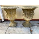 A PAIR OF GARDEN URNS with classical motif, 56cm tall approx.