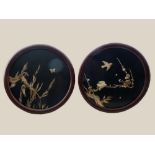 A PAIR OF EARLY 20TH CENTURY CIRCULAR ASIAN WALL PLAQUES, with ebonised frames, the inlaid ivory