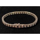 AN 18CT WHITE GOLD DIAMOND TENNIS BRACELET, with 5.40cts of diamond, in excellent as new condition