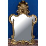 A GILT HALL MIRROR with large ‘Prince of Wales feather’ surmount, having scroll, foliage & bead