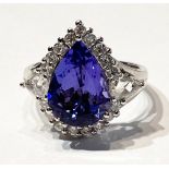 AN EXQUISITE 18CT WHITE TANZAINTE & DIAMOND CLUSTER RING, the Tanzanite is a great example of this
