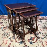 A NEST OF THREE TABLES, Mahogany and satinwood cross banded side tables, raised on lyre supports,