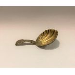 A GEORGIAN SIVER CADDY SPOON in shell form with engraved decoration on handle, Maker William Fearn