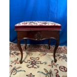 A VICTORIAN LIFT TOP PIANO STOOL, with tapestry decorated cushioned seat which opens to reveal
