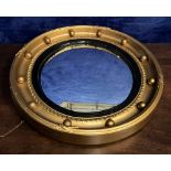 A WILLIAM IV GILTWOOD CONVEX MIRROR, with ball encrusted frame, round gilt mirror, 48cms diameter