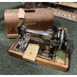 A CASED SINGER SEWING MACHINE ALONG WITH A HANGING BRACKET