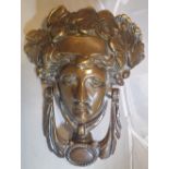 A 19TH CENTURY BRASS ‘ANNA LIVIA’ DOOR KNOCKER, 17.1cm x 12.7cm x 5.1cm approx