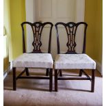 A PAIR OF WELL CARVED CHIPPENDALE SIDE CHAIRS, with acanthus leaf draped shoulders and rest rail,