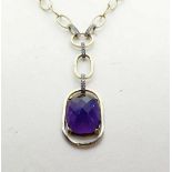 A 9CT DIAMOND AND GOLD AMETHYST NECKLACE, large cushion cut amethyst gemstone set in yellow gold