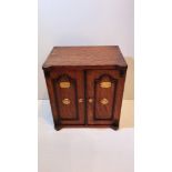 A 19TH CENTURY OAK JEWELLERY CABINET, or smoker’s cabinet, in the form of a safe, with two doors