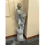 A LARGE GARDEN ORNAMENTAL FIGURE, of a woman holding a water churn, 164cm high approx.