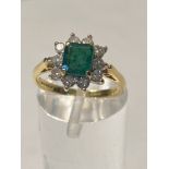 AN 18CT YELLOW GOLD EMERALD & DIAMOND CLUSTER RING, a timeless classic this handmade superior