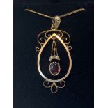 A 9CT YELLOW GOLD ART NOUVEAU GARNET & SEED PEARL PENDANT, complete with a yellow gold chain