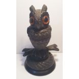 A 19TH CENTURY BOG OAK CARVED ORNAMENT OF AN OWL, well carved, with large amber eyes, 10.8cm (H) x