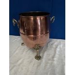 A COPPER BARREL SHAPED COAL BUCKET, on brass feet